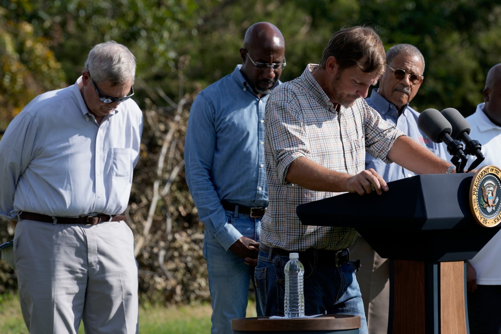 Buck Paulk, property manager of Shiloh Pecan Farm, spoke about Hurricane Helene damage in Ray City, Georgia. Listening are (left to right): Department of Agriculture Secretary Tom Vilsack, U.S. Sen. Raphael Warnock and Rep. Sanford Bishop.