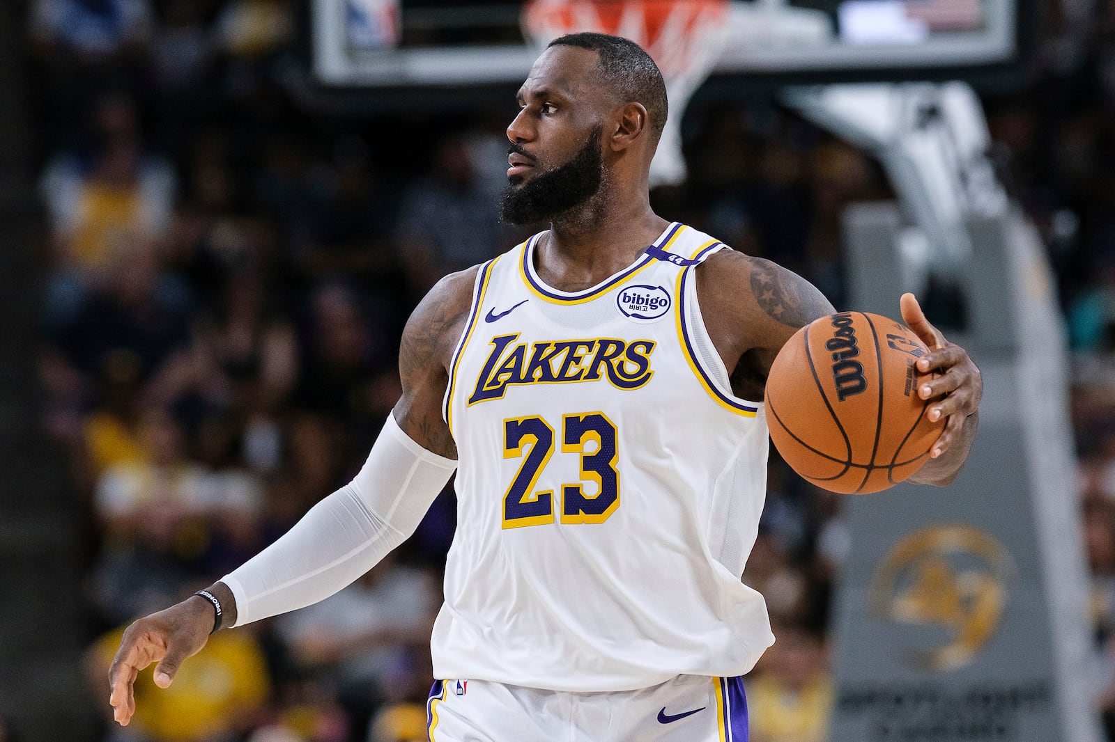 Los Angeles Lakers forward LeBron James (23) dribbles the ball during the first half of a preseason NBA basketball game against the Phoenix Suns, Sunday, Oct. 6, 2024, in Palm Desert, Calif. (AP Photo/William Liang)