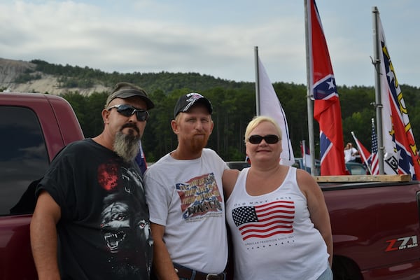 Joel Colston (left) and Dike Young pose for a photo with a friend at a Confederate flag rally at Stone Mountain Park on Friday, August 1, 2015. DANIEL FUNKE / DANIEL.FUNKE@COXINC.COM