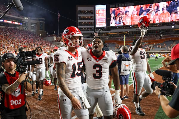 Georgia quarterback Carson Beck (15) and Georgia linebacker CJ Allen (3) celebrate their 30-15 win against Texas at Darrel K Royal Texas Memorial Stadium, Saturday, October 19, 2024, in Austin, Tx. (Jason Getz / AJC)

