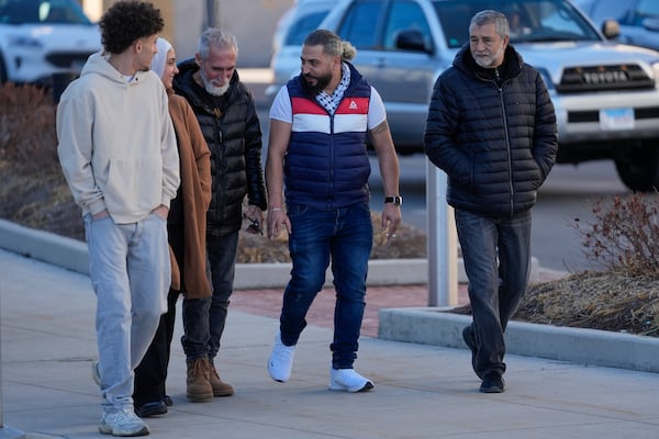 Odai Alfayoumi, second from right, father of six-year-old Palestinian boy Wadee Alfayoumi, leaves Will County Courthouse with others where Joseph Czuba, 73, is charged with and on trial in the fatal stabbing of the boy and the wounding of his mother Hanan Shaheen, Tuesday, Feb. 25, 2025, in Joliet, Ill. (AP Photo/Erin Hooley)