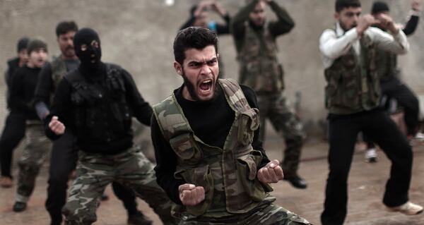 FILE - In this Dec. 17, 2012, file photo, Syrian rebels attend a training session in Maaret Ikhwan near Idlib, Syria. Fewer than 100 Syrian rebels are currently being trained by the U.S. military to fight the Islamic State group, a tiny total for a sputtering program with a stated goal of producing 5,400 fighters a year. (AP Photo/Muhammed Muheisen, File)