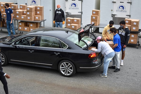 Meals On Wheels Atlanta volunteers load a vehicle for meal deliveries.