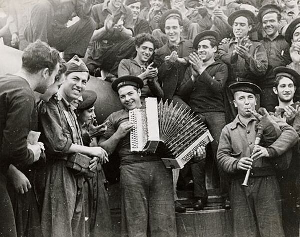 Republican sailors playing musical instruments on board the battleship Jaime I, Almería, Spain. February 1937.