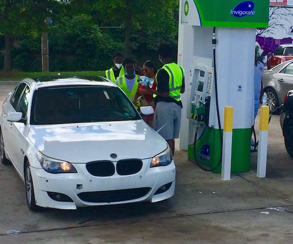 A customer at the BP at the corner Northside Drive and Joseph E. Boone Boulevard is popular with teens peddling water. Photo by BILL TORPY