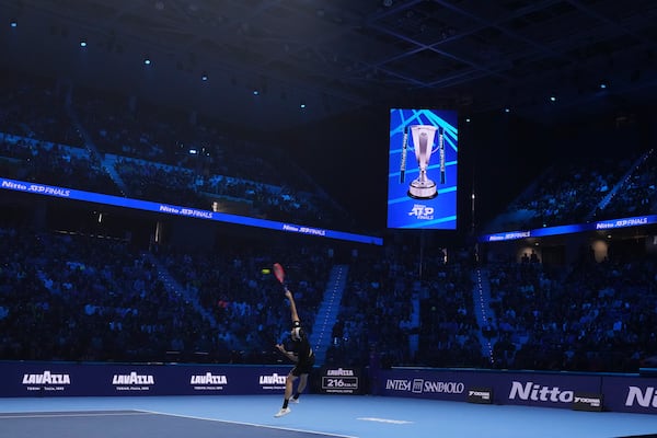 United States' Taylor Fritz serves the ball to Australia's Alex de Minaur during their singles tennis match of the ATP World Tour Finals at the Inalpi Arena, in Turin, Italy, Thursday, Nov. 14, 2024. (AP Photo/Antonio Calanni)