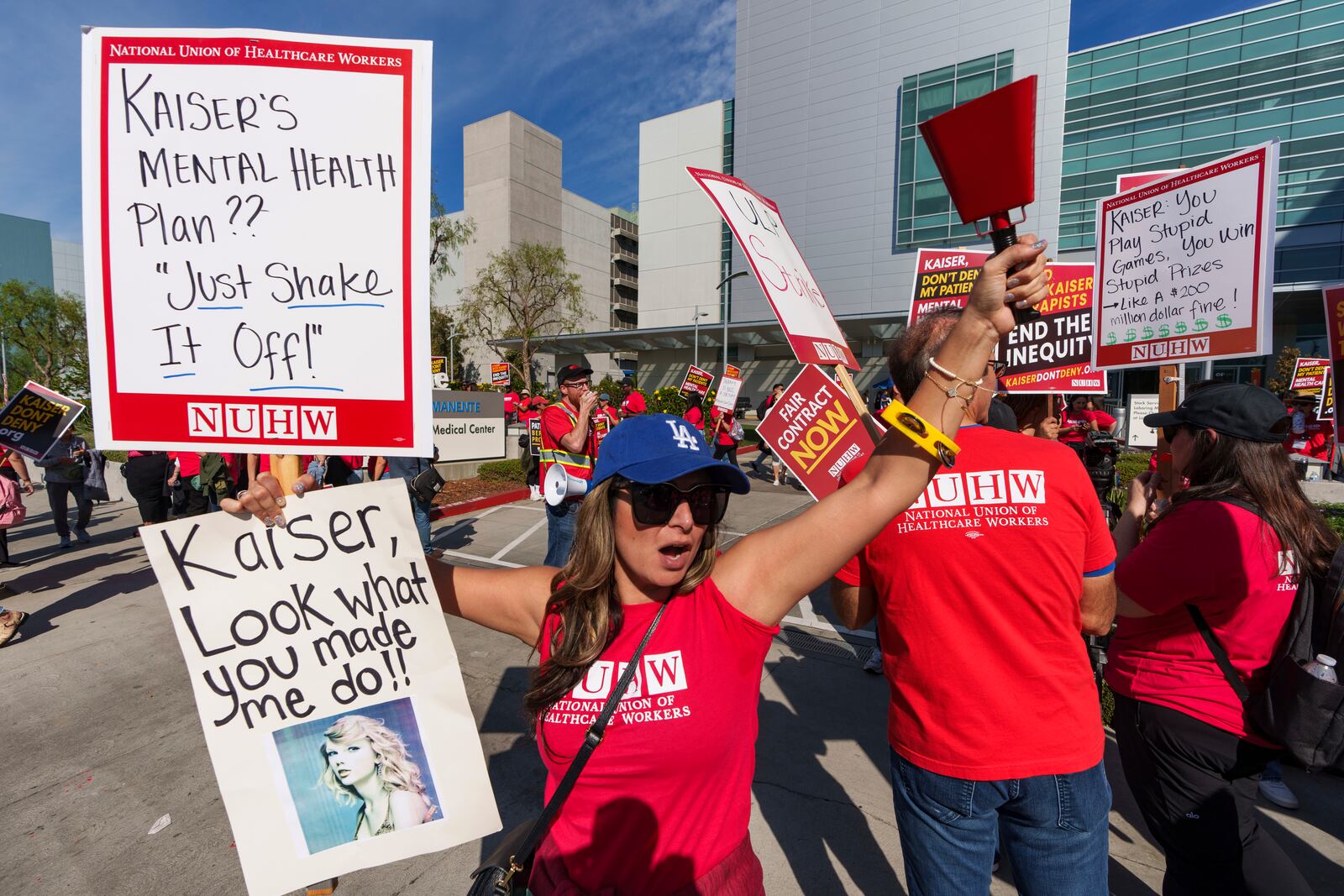 Amy Rocha, a psychiatric social worker, joins mental health workers at outside a Kaiser Permanente building as they begin an open-ended strike in Los Angeles on Monday, Oct. 21, 2024. (AP Photo/Damian Dovarganes)