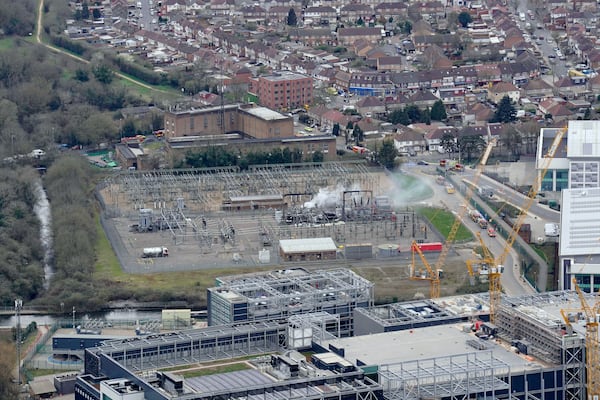 Smoke rises from the North Hyde electrical substation, which caught fire last night, leading to the closure of the Heathrow Airport, in London, Friday March 21, 2025. (Jonathan Brady/PA via AP)