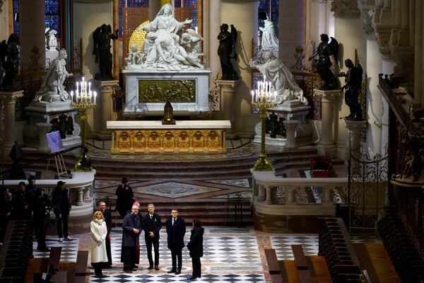 French President Emmanuel Macron, second right, and his wife Brigitte Macron visit the restored interiors of the Notre-Dame de Paris cathedral, Friday, Nov. 29, 2024 in Paris. (Sarah Meyssonnier/Pool via AP)