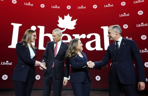 Liberal Party of Canada leadership candidates Karina Gould, Frank Baylis, Chrystia Freeland and Mark Carney greet one another prior to the English-language Liberal Leadership debate in Montreal on Tuesday, Feb. 25, 2025. (Christinne Muschi/The Canadian Press via AP)