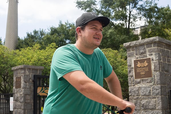 08/20/2019 -- Atlanta, Georgia -- Derek Captain of Florida talks about e-scooters while riding a shareable e-scooter near Centennial Olympic Park in Atlanta, Tuesday, August 20, 2019. (Alyssa Pointer/alyssa.pointer@ajc.com)