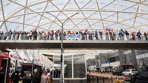 Demonstrators chant from the bridge during the Delta Airlines pro-union flight attendants rally on Thursday, March 25, 2023, at Hartsfield-Jackson airport in Atlanta. Delta employees including flight attendants and pilots as well as other pro-union organizers rallied outside of the airport's south terminal. CHRISTINA MATACOTTA FOR THE ATLANTA JOURNAL-CONSTITUTION. 