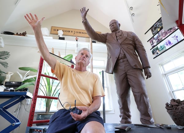 072820 Cumming: Sculptor Gregory Johnson explains how he chose the strong gesture he is using on a one and one-third life size statue of John Lewis made with 800 pounds of clay that will be cast in bronze at his studio on Tuesday, July 28, 2020 in Cumming.    Curtis Compton ccompton@ajc.com