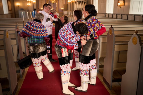 Salik Schmidt and Malu Schmidt arrive at the church of our Savior before getting married in Nuuk, Greenland, Saturday, Feb. 15, 2025. (AP Photo/Emilio Morenatti)