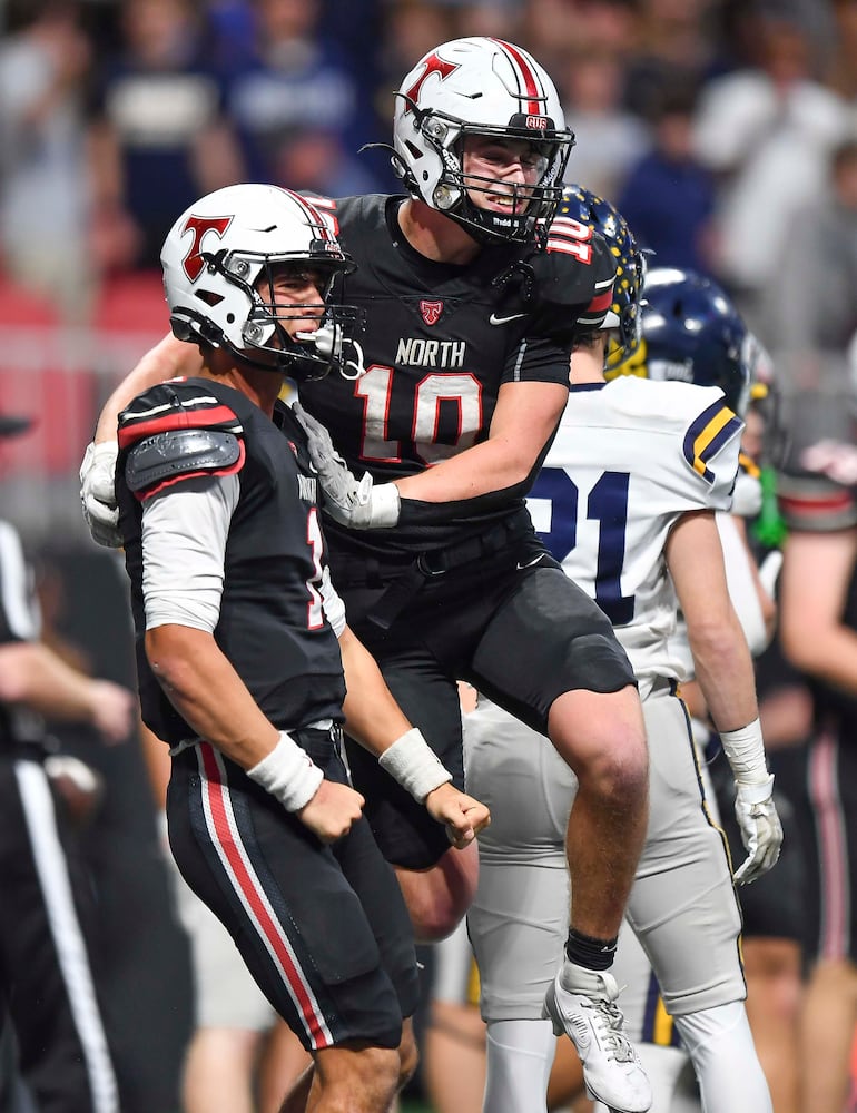 North Oconee’s quarterback Harrison Faulkner (1) celebrates his touchdown run with JT Doster (10) during the second half of a Class 4A championship game at the Mercedes-Benz Stadium Monday, Dec. 16, 2024. 