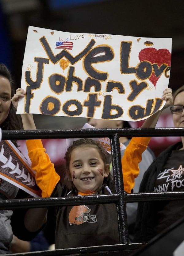 Emma Kohler, 7, of Atlanta looks at the field before the first half of an NFL football game between the Atlanta Falcons and the Cleveland Browns, Sunday, Nov. 23, 2014, in Atlanta. (AP Photo/John Bazemore)