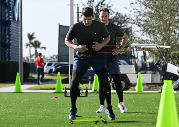 Atlanta Braves third base Austin Riley (foregound) and first base Matt Olson warm up during the first of the Braves pitchers and catchers report to spring training at CoolToday Park, Wednesday, February 12, 2025, North Port, Florida. (Hyosub Shin / AJC)