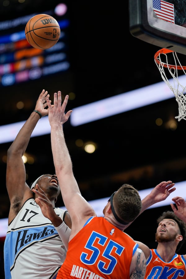 Atlanta Hawks forward Onyeka Okongwu (17) shoots against Oklahoma City Thunder center Isaiah Hartenstein (55) during the first half of an NBA basketball game, Friday, Feb. 28, 2025, in Atlanta. (AP Photo/Mike Stewart)