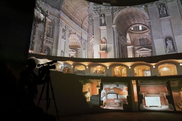 Images of St. Peter's Basilca are projected on a screen during the preview to the press of the exhibition 'Petros eni', which is part of the project "St. Peter's Basilica: AI-Enhanced Experience" at the Vatican, Saturday, Nov. 9, 2024. (AP Photo/Gregorio Borgia)