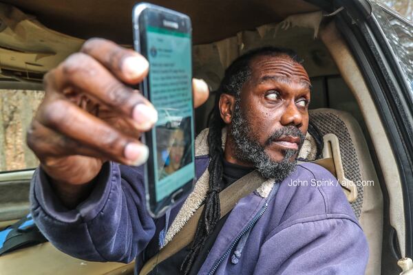 Tyron Bush holds a cellphone photo of a missing woman he says looks like the stabbed woman he hit on Butner Road on Tuesday night.