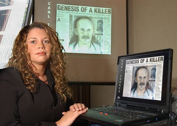 050808 ATLANTA, GA:   Paige Seagraves (cq) of Athens, GA, who is the granddaughter of Ned Alday (cq), patriarch of the Alday family of Seminole County, GA,  with one of the newspaper clippings she uses in her presentation  about the 1973 Alday family  murders  prior to speaking to members of the National Organization for Victim Assistance at its 2005 annual conference in downtown Atlanta at the Hilton Hotel Monday 8/8/05.  (Kimberly Smith/staff)