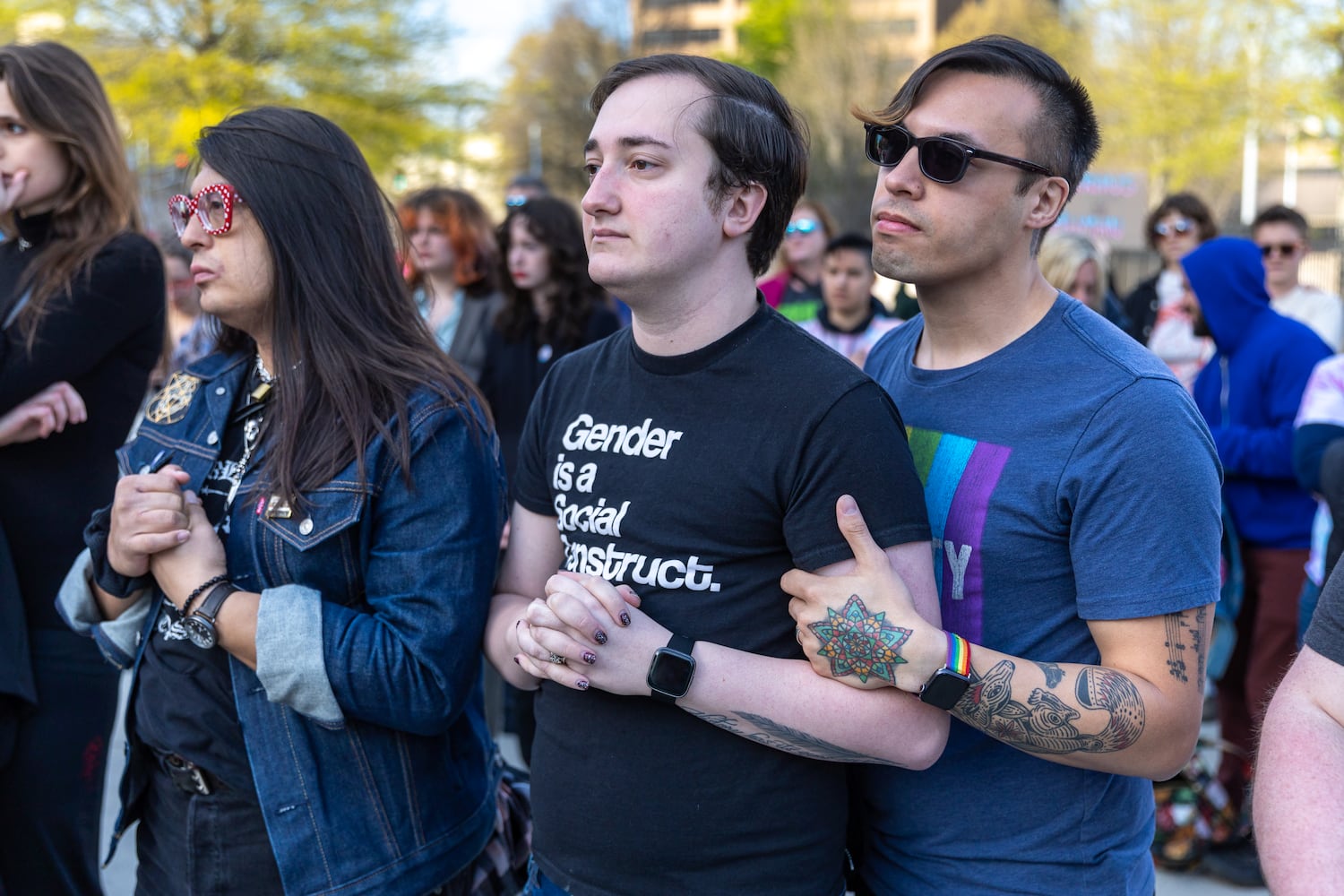 (L-R) Mykal June, Jace Johns-Cooper and Nicholas Johns-Cooper attend a rally against SB 140 outside the Capitol in Atlanta on Monday, March 20, 2023. SB 140 would prevent medical professionals from giving transgender children certain hormones or surgical treatment. (Arvin Temkar / arvin.temkar@ajc.com)