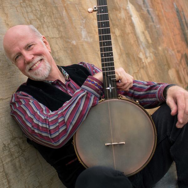 A promotional photograph of singer-songwriter John McCutcheon, pictured here with one of his banjos. 
Courtesy of Irene Young.