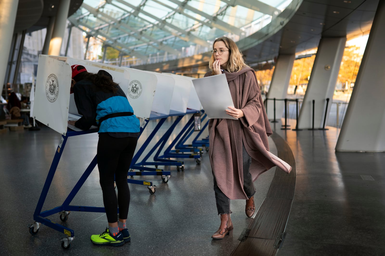 FILE - A voter moves to cast her ballot at an electronic counting machine at a polling site at the Brooklyn Museum, Nov. 8, 2022, in the Brooklyn borough of New York. ( AP Photo/John Minchillo, File)