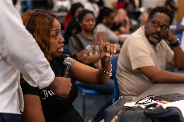 Carver community member Kimberly Brooks tells Johnson the area needs more resources and support. “These kids matter to me,” she said. “They are graduating and they can’t read. They can’t get a job. This is our duty and responsibility.” (Seeger Gray / AJC)