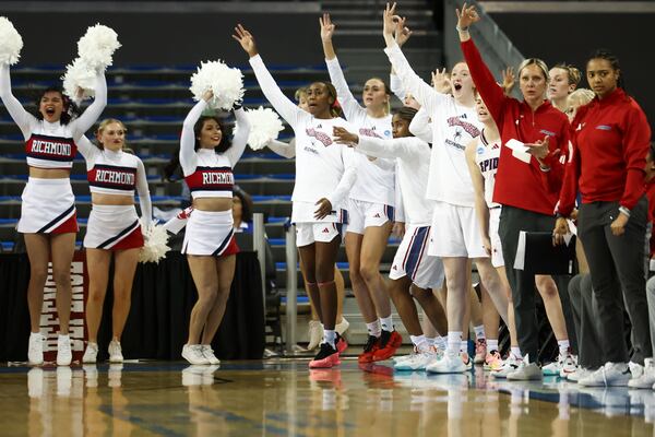 Richmond forward Sam Dewey (13) and additional teammates and staff on the bench gesture after a three point basket against Georgia Tech during the first half in the first round of the NCAA college basketball tournament, Friday, March 21, 2025, in Los Angeles. (AP Photo/Jessie Alcheh)