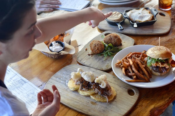 Twain’s Brewpub & Billiards executive chef Savannah Sasser gives details on an assortment of menu items from her kitchen. (photo: HENRI HOLLIS)