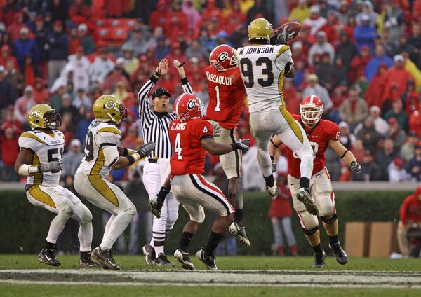 ATHENS, GA - NOVEMBER 29: Wide receiver Mohamed Massaquoi #1 of the Georgia Bulldogs and defensive end Michael Johnson #93 of the Georgia Tech Yellow Jackets collide while trying to catch an errant pass during the game at Sanford Stadium on November 29, 2008 in Athens, Georgia. The Yellow Jackets beat the Bulldogs 45-42. (Photo by Mike Zarrilli/Getty Images) Johnson finished his Tech career with 30.5 tackles for loss, which was tied for 16th at the end of his career. (GETTY IMAGES)