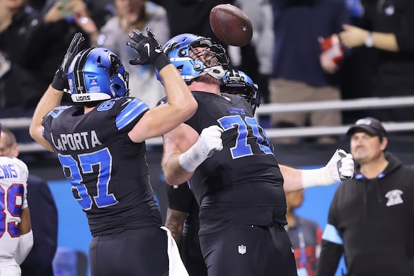 Detroit Lions offensive tackle Dan Skipper, right, celebrates with tight end Sam LaPorta (87) after scoring against the Buffalo Bills during the first half of an NFL football game, Sunday, Dec. 15, 2024, in Detroit. (AP Photo/Rey Del Rio)