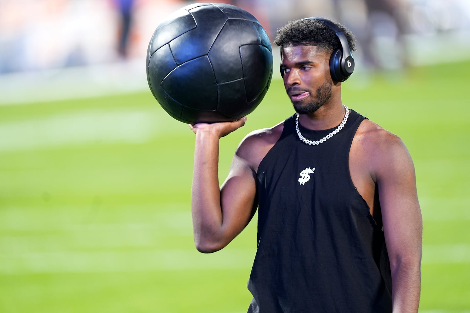 Colorado quarterback Shedeur Sanders warms up before an NCAA college football game against Kansas State, Saturday, Oct. 12, 2024, in Boulder, Colo. (AP Photo/David Zalubowski)