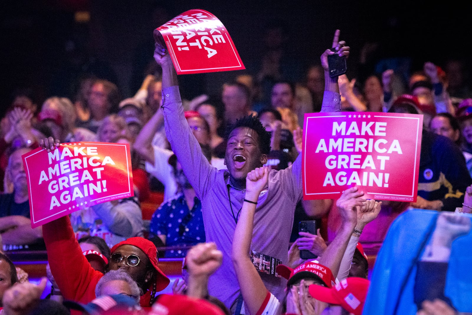 Supporters cheer for Republican presidential candidate Donald Trump to speak at his campaign rally Oct. 15 at the Cobb Energy Performing Arts Center. (Arvin Temkar / AJC)