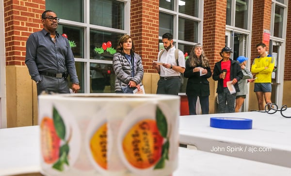 Voters wait to cast their ballots Tuesday morning at Grady High School