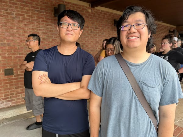 Danny Kim of Lawrenceville (left) and Eric Trinh of Kennesaw waited more than 20 minutes to get into the Teso Life store in Duluth Saturday afternoon.