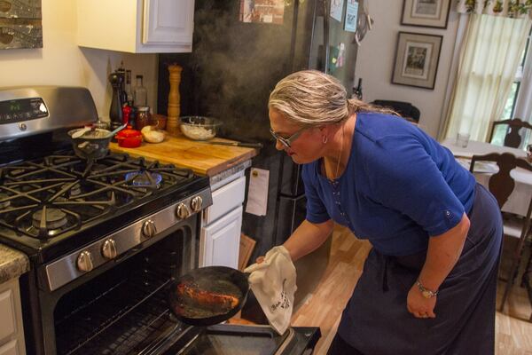 Virginia Willis, a southern chef, prepares a meal at her home in Vinings. Willis’ new cookbook is “Secrets of the Southern Table: A Food Lover’s Tour of the Global South.” REANN HUBER/REANN.HUBER@AJC.COM