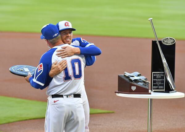 Braves first baseman Freddie Freeman (5) hugs Hall of Famer Chipper Jones as he is presented the MVP Award for the 2020 season before game against Philadelphia Phillies Sunday, April 11, 2021, at Truist Park in Atlanta. (Hyosub Shin / Hyosub.Shin@ajc.com)