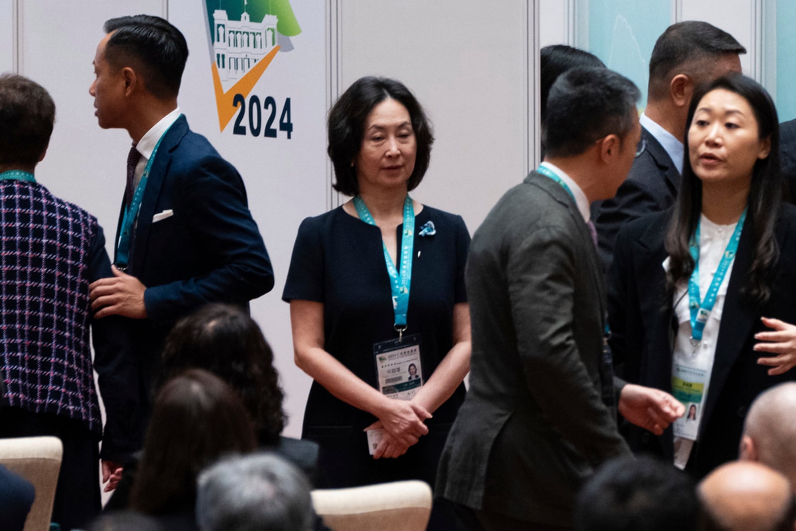 Shun Tak Holdings' group executive chairperson Pansy Ho, center, daughter of late casino tycoon Stanley Ho, waits in line to vote during the chief executive election in Macao, Sunday, Oct. 13, 2024. (AP Photo/Bertha Wang)