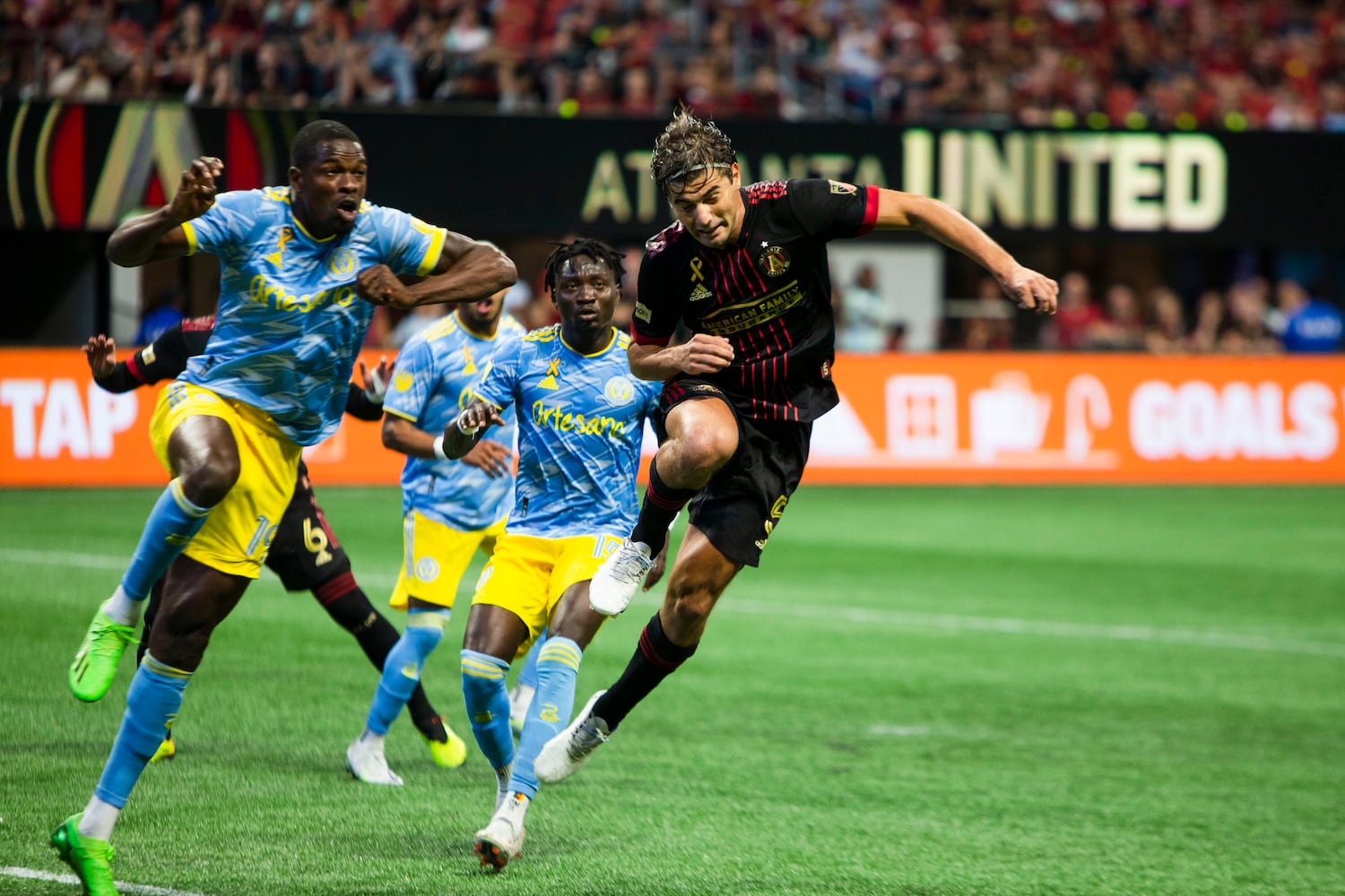 Cory Burke (left), forward for Philadelphia Union, and Santiago Sosa (right) of Atlanta United jump for a header off of the corner kick. CHRISTINA MATACOTTA FOR THE ATLANTA JOURNAL-CONSTITUTION.