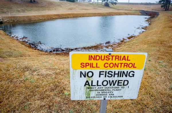 Standing water collects in a spill pond on Dobbins Air Reserve Base Friday, in Marietta. The spill pond was among those impacted by contamination from a special firefighting foam used by the military. STEVE SCHAEFER / SPECIAL TO THE AJC