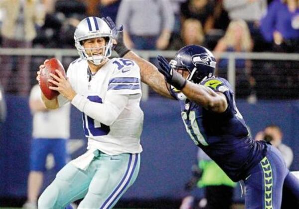 Seahawks Bruce Irvin, right sacks Cowboys' Matt Cassel during Seattle's 13-12 win on Sunday, Nov. 1, 2015. (Brandon Wade / Associated Press)