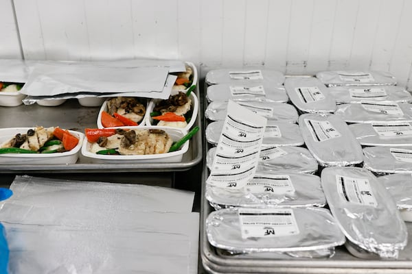 Mainline Aviation employees package meals for in-flight catering on Friday, August 5, 2022. (Natrice Miller/natrice.miller@ajc.com)