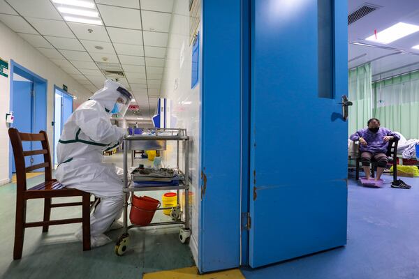 A nurse takes notes in the isolation ward for coronavirus patients in Wuhan.