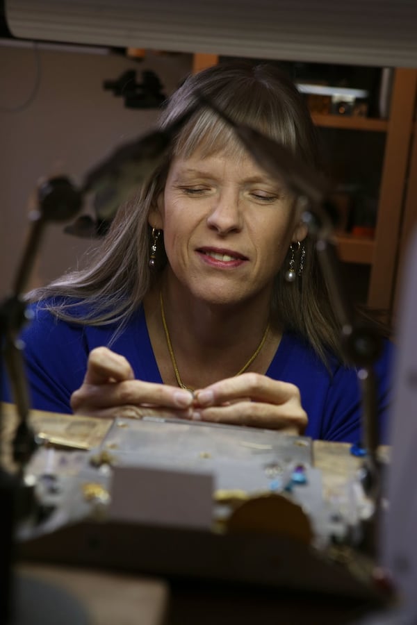 Kathy Kinev, an award-winning jeweler from Atlanta, works on small pieces of jewelry. HENRY TAYLOR / HENRY.TAYLOR@AJC.COM