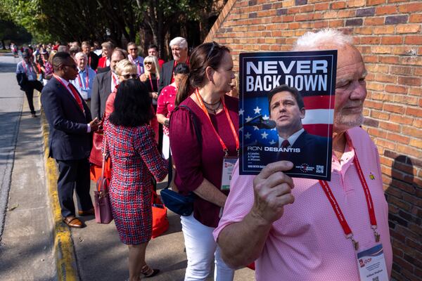 William Bingham, a delegate from Walton County, holds a Ron DeSantis flyer while in line to hear former President Donald Trump speak at the Georgia GOP convention in Columbus on Saturday, June 10, 2023. (Arvin Temkar / arvin.temkar@ajc.com)