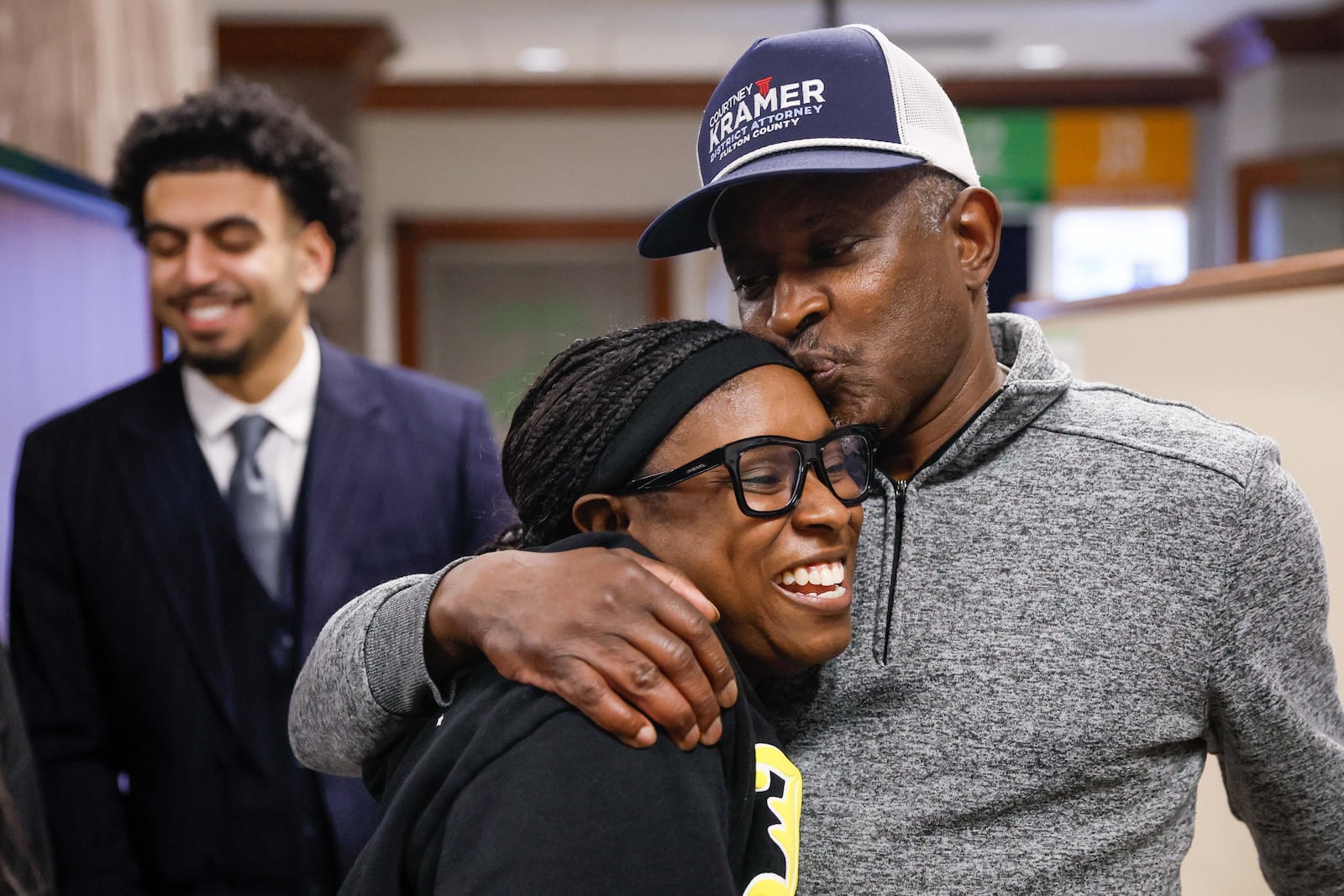 Jefferey Williams Sr., the father of Atlanta rapper Young Thug, kisses daughter Hidoraah Williams as they leave Fulton County Superior Court on Thursday.