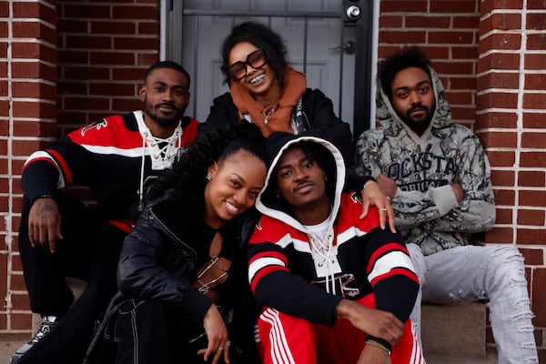 Children of the Dungeon Family pose for a portrait in front of the original Dungeon Family home in Atlanta on Monday, Feb. 17, 2025. (Natrice Miller/ Natrice.miller@ajc.com)