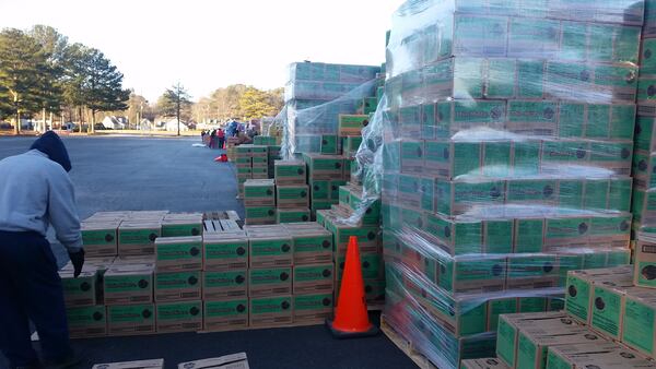 A warehouse worker checks a load of Girl Scout cookies for loading into a warehouse in metro Atlanta in 2020.